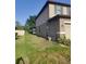 Side yard with well-maintained lawn and partial fence at 2120 Lilipetal Ct, Sanford, FL 32771
