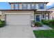 Inviting two-story home with a well-maintained lawn and a two-car garage at 2120 Lilipetal Ct, Sanford, FL 32771