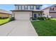 Inviting two-story home with a well-maintained lawn and a two-car garage at 2120 Lilipetal Ct, Sanford, FL 32771