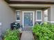 Cozy front porch with seating and decorative wreath on a blue-painted front door at 2120 Lilipetal Ct, Sanford, FL 32771