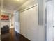 Hallway with dark wood floors, white wainscoting, and a laundry room at 2120 Lilipetal Ct, Sanford, FL 32771