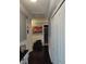 Hallway featuring dark wood floors, white wainscoting, and access to multiple rooms at 2120 Lilipetal Ct, Sanford, FL 32771