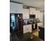 Stainless steel appliances with white cabinets and dark granite countertops enhance this kitchen at 2120 Lilipetal Ct, Sanford, FL 32771