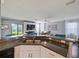 Granite countertop bar open to a living area with a fireplace and ample natural light at 2120 Lilipetal Ct, Sanford, FL 32771