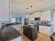 Spacious kitchen with granite countertops, stainless appliances, a dark wood island, and pendant lighting at 2120 Lilipetal Ct, Sanford, FL 32771
