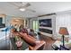 Bright living room with fireplace, hardwood floors, and open to dining area at 2120 Lilipetal Ct, Sanford, FL 32771