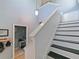 Staircase with white bead-board walls, black treads, and a charming pendant light fixture at 2120 Lilipetal Ct, Sanford, FL 32771