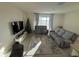 Bright living room with sliding glass doors, comfortable seating, and neutral tones at 2252 Tay Wes Dr, St Cloud, FL 34771