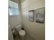 Clean and simple powder room featuring a toilet and artistic décor at 2252 Tay Wes Dr, St Cloud, FL 34771