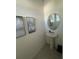 Stylish powder room featuring a pedestal sink, modern artwork, and tile flooring at 2252 Tay Wes Dr, St Cloud, FL 34771