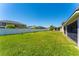 Large backyard with lush grass, a privacy fence, and views of neighboring houses at 2340 Hinsdale Dr, Kissimmee, FL 34741