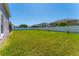 Large backyard featuring grass and a privacy fence with views of the neighboring houses at 2340 Hinsdale Dr, Kissimmee, FL 34741
