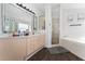 Bright bathroom featuring a soaking tub, walk-in shower, and wood-look floors at 2340 Hinsdale Dr, Kissimmee, FL 34741