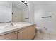 A clean, bright bathroom featuring a large mirror, and a vanity with storage below at 2340 Hinsdale Dr, Kissimmee, FL 34741