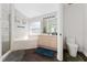 Bright bathroom featuring a soaking tub, walk-in shower, and wood-look floors at 2340 Hinsdale Dr, Kissimmee, FL 34741