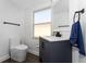 Updated half bath with navy vanity, wood-look floors, and modern fixtures at 2340 Hinsdale Dr, Kissimmee, FL 34741