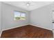 Empty bedroom with hardwood floors, neutral paint, ceiling fan, and large window at 2340 Hinsdale Dr, Kissimmee, FL 34741