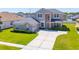 Two-story home featuring a long driveway, manicured lawn, and mature shrubbery at 2340 Hinsdale Dr, Kissimmee, FL 34741