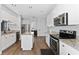 Bright kitchen features white cabinets, stainless steel appliances, granite countertops and luxury vinyl plank flooring at 2340 Hinsdale Dr, Kissimmee, FL 34741