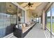 Enclosed patio with ceiling fans, comfortable seating and access to the kitchen at 2340 Hinsdale Dr, Kissimmee, FL 34741