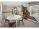 Bright bonus room with neutral decor, large windows, a round white table, and modern accents at 2363 Distant Sun Trl, Kissimmee, FL 34747