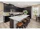 Modern kitchen with dark cabinets, a spacious island, and stainless steel appliances at 2363 Distant Sun Trl, Kissimmee, FL 34747