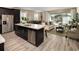 Open-concept kitchen flows into the living room with access to the lanai and pool at 2363 Distant Sun Trl, Kissimmee, FL 34747