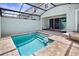 Private pool featuring steps, a screened enclosure, brick pavers, and comfortable lounge chairs at 2363 Distant Sun Trl, Kissimmee, FL 34747