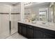 Bathroom with a double sink vanity, walk in shower with glass door and stylish fixtures at 2367 Distant Sun Trl, Kissimmee, FL 34747
