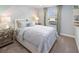 Cozy bedroom with large window, carpet floors, and accent pillows at 2367 Distant Sun Trl, Kissimmee, FL 34747