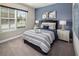 Comfortable bedroom featuring a blue accent wall, plush carpet, and ample natural light at 2367 Distant Sun Trl, Kissimmee, FL 34747