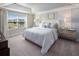 Spacious bedroom featuring tray ceilings, large window, and neutral color palette at 2367 Distant Sun Trl, Kissimmee, FL 34747