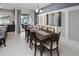Elegant dining area with modern table and chairs near sliding door and accent wall at 2367 Distant Sun Trl, Kissimmee, FL 34747