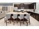 Modern open-concept kitchen featuring an oversized island with dark wood cabinets at 2367 Distant Sun Trl, Kissimmee, FL 34747
