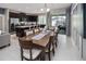 Open-concept kitchen and dining area with stainless steel appliances and view of the pool at 2367 Distant Sun Trl, Kissimmee, FL 34747