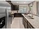 Stylish kitchen with modern appliances, granite countertops, and center island at 2367 Distant Sun Trl, Kissimmee, FL 34747