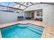 Sparkling pool with sun-shelf and screened enclosure at 2367 Distant Sun Trl, Kissimmee, FL 34747