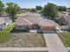 An aerial view of a single-story brick home with attached garage in a quiet neighborhood at 2470 Pine Tree Circle Dr, Orange City, FL 32763