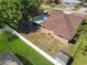 Aerial view of backyard with lush lawn, fencing, and screened-in patio at 2470 Pine Tree Circle Dr, Orange City, FL 32763