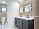 Stylish bathroom featuring double vanity, modern mirrors, decorative walls, and tiled floors at 2470 Pine Tree Circle Dr, Orange City, FL 32763