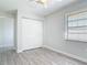 Bright bedroom with wood-look floors, closet and natural light creating a welcoming and serene space at 2470 Pine Tree Circle Dr, Orange City, FL 32763