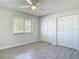 This bright bedroom features stylish wood-look floors, a ceiling fan, and large window for natural light at 2470 Pine Tree Circle Dr, Orange City, FL 32763