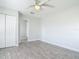This bedroom features wood-look floors, a ceiling fan, and nearby doorway leading to another room at 2470 Pine Tree Circle Dr, Orange City, FL 32763