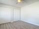 Bright bedroom featuring tile floors, two large closets, and a ceiling fan at 2470 Pine Tree Circle Dr, Orange City, FL 32763