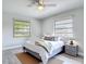 Comfortable bedroom featuring wood-look floors, and two windows, creating a relaxing and inviting space at 2470 Pine Tree Circle Dr, Orange City, FL 32763
