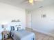 Cozy bedroom featuring light wood-look tile, neutral walls, and a well-lit bedside decor at 2470 Pine Tree Circle Dr, Orange City, FL 32763