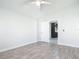 Bright bedroom with neutral walls, wood-look tile floors, and a ceiling fan with overhead lighting at 2470 Pine Tree Circle Dr, Orange City, FL 32763