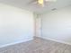 Airy bedroom featuring wood-look tile flooring, neutral walls, and a ceiling fan with overhead lighting at 2470 Pine Tree Circle Dr, Orange City, FL 32763