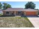 Charming brick single-story home with a two-car garage and well-maintained front yard at 2470 Pine Tree Circle Dr, Orange City, FL 32763
