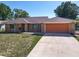 Charming brick single-story home with a two-car garage and well-maintained front yard at 2470 Pine Tree Circle Dr, Orange City, FL 32763